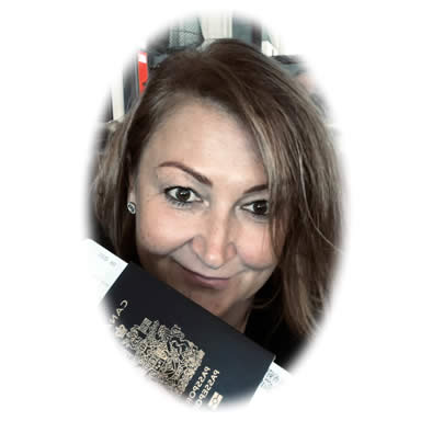 Irena Struk head shot in her office holding a passport and airline tickets