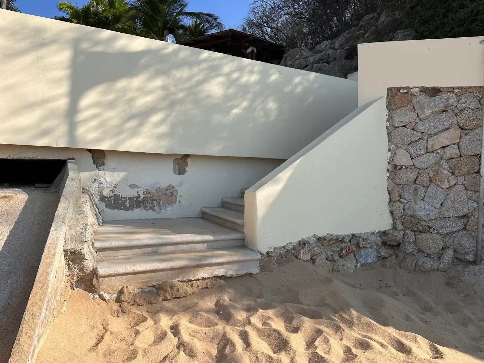 The entrance to the beach where the sand was washed away by a hurricane, leaving a tall step down