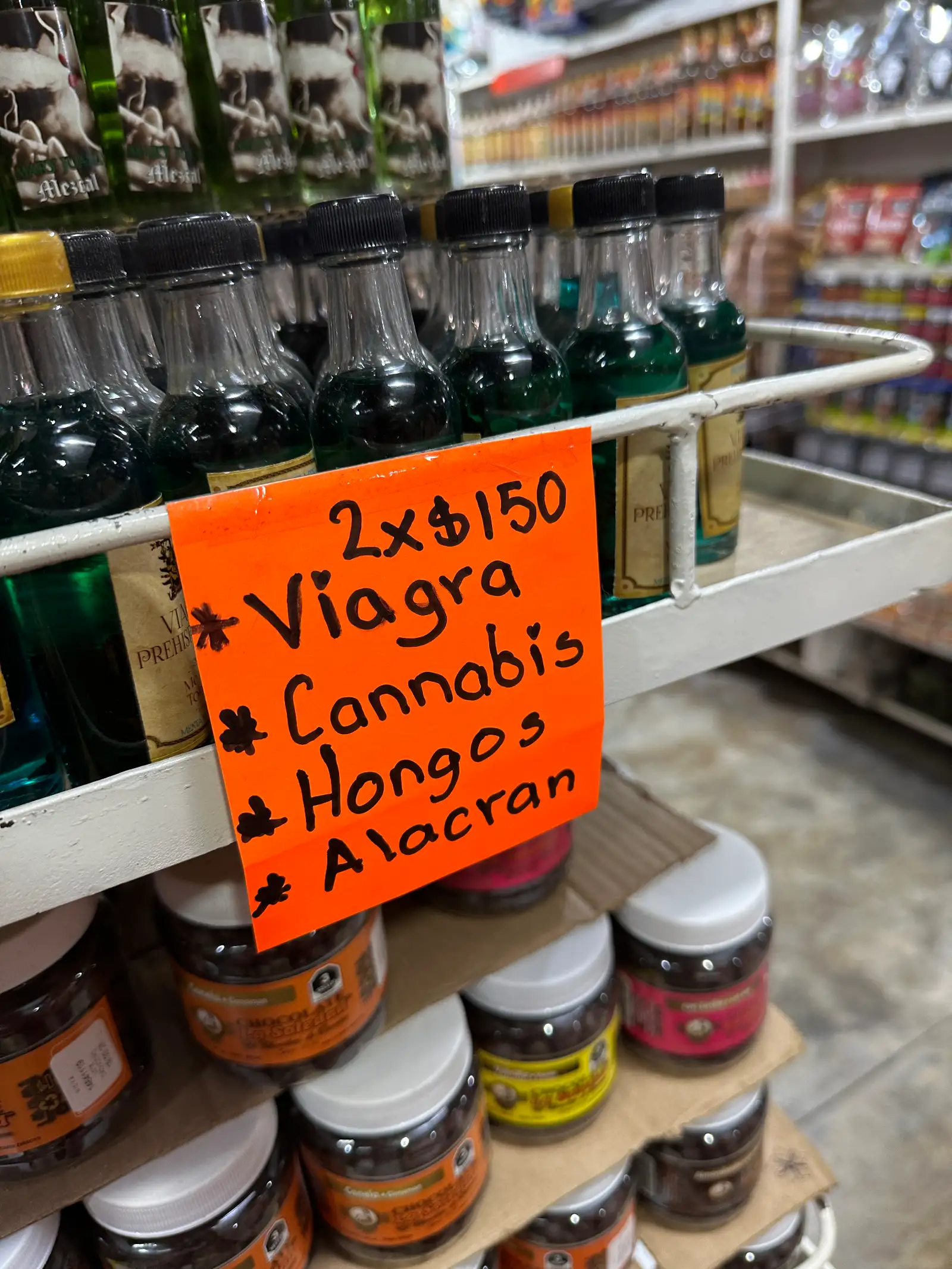 A local store with a handwritten sticky note advertising deals on Viagra and cannabis products