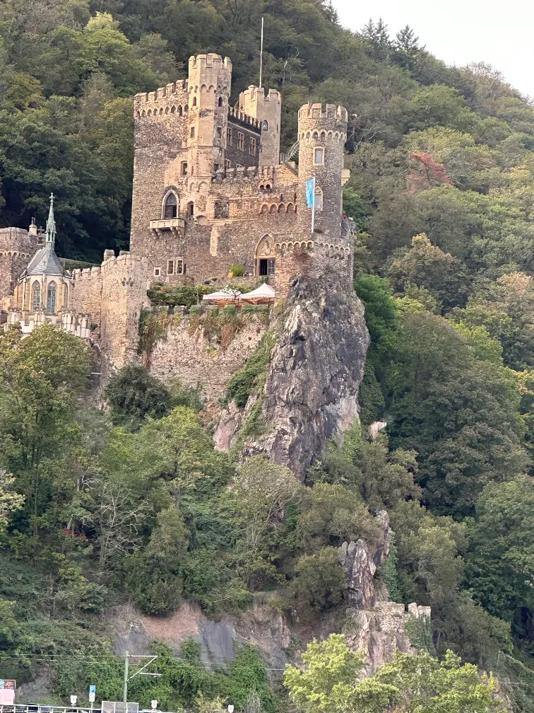 A medieval hilltop castle along the Rhine Valley viewed from a river cruise boat