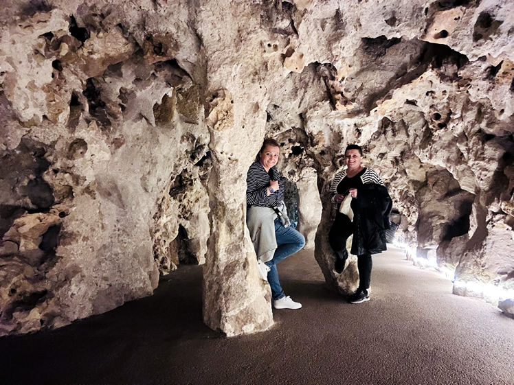 Struck by Travel team exploring a cave on a group excursion