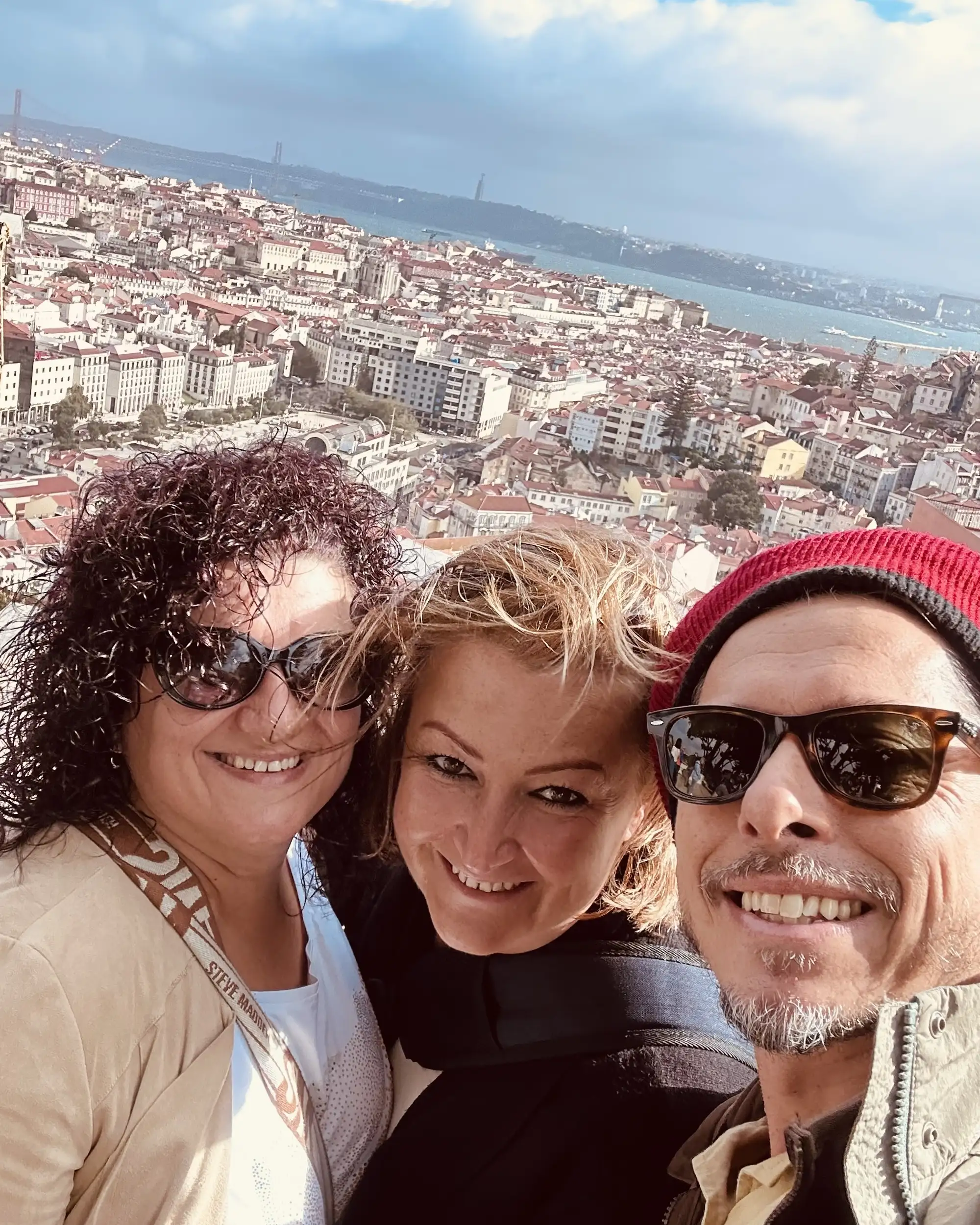 Struck by Travel staff pose while looking at the sites seen in background